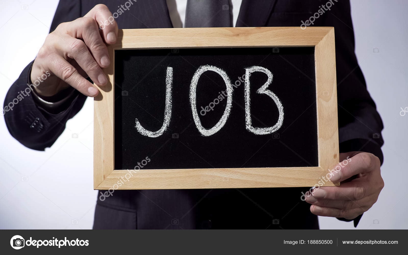 Job written on blackboard, male hands holding sign, business concept
