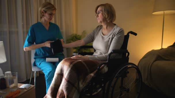 Female nurse measuring woman blood pressure, hypertension, old age hopelessness — Stock Video