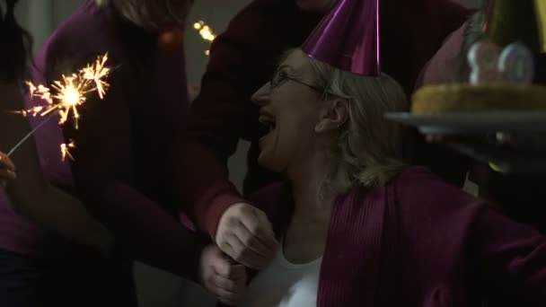 Amigos y familiares abrazando a la mujer feliz en su fiesta de cumpleaños 80, celebración — Vídeo de stock