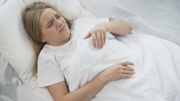 Capricious teenage girl refuses to wake up, pulling on blanket, lazy morning — Stock Video