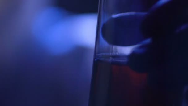 Male police worker taking fingerprints by brush from evidence glass bottle — Stock Video