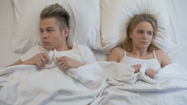 Νεαρός άνδρας και γυναίκα, ψάχνει σε δύσκολη θέση πριν από την πρώτη οικειότητα στο κρεβάτι, ανασφάλεια — Αρχείο Βίντεο