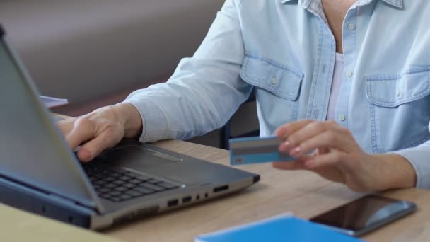 Senior dame invoeren van gegevens van haar kaart, betalen van rekeningen en doen online winkelen — Stockvideo