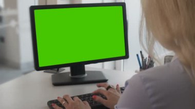 Yeşil ekran ile kişisel bilgisayar belgeleri yazarak işçisi kadın ofis