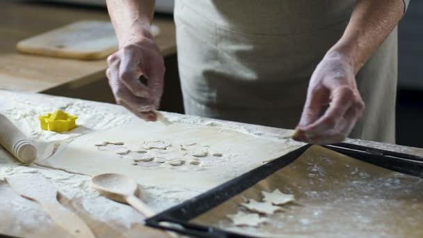 Grandmother putting out star shape cookies on baking pan, traditional recipe — Stock Video