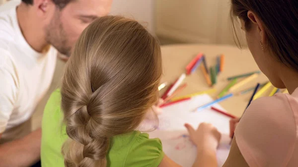 Family drawing colorful pictures with pencils, parents enjoying time with kid — Stock Photo, Image