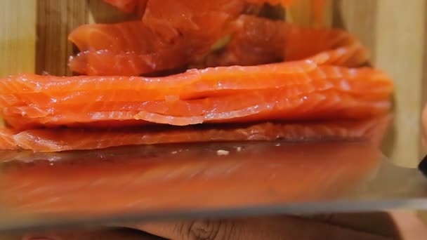 Huisvrouw snijden zalm in keuken, hoge omega zuren en vitaminegehalte — Stockvideo