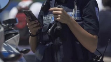 Kadın polis memuru cep telefonuyla sokak, tehlikeli meslek