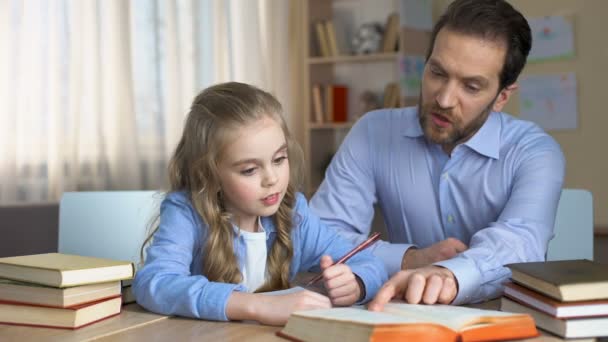 Smiling Tutor Helping Little Girl Learn New Words Doing Homework — Stock Video