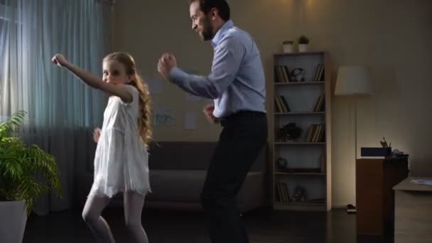 Hijita y padre disfrutando bailando en casa, divirtiéndose juntos, fiesta — Vídeos de Stock