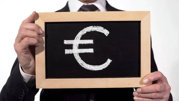 Euro symbol drawn on blackboard in businessman hands, European currency, finance — Stock Photo, Image