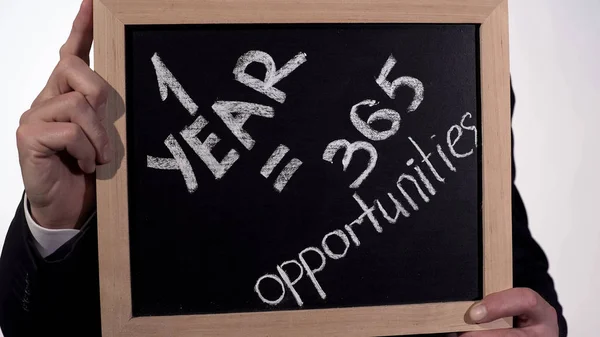 One year is 365 opportunities motivation on blackboard in businessman hands — Stock Photo, Image