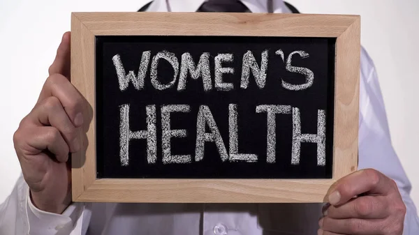 Kvinnor hälsa skrivit på tavlan i gynekolog händer, reproduktionsmedicin — Stockfoto