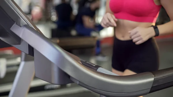 Düz mide ve ince kalça aktif genç kadının spor salonunda treadmill yürüyüş — Stok fotoğraf