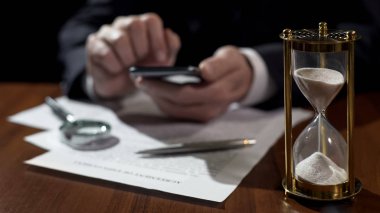Kum saati saat, elektronik dosyaları üstünde becerikli alet ile ilgilenen şirket müdürü ölçme