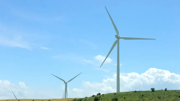 Wind turbines against amazing blue sky background, alternative energy innovation — Stock Photo, Image