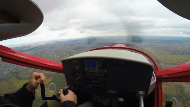 POV of second pilot of training plane flying over village, dangerous sport, extreme — стоковое видео