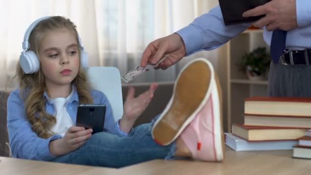 Niña adolescente malcriada en auriculares exigiendo dinero de bolsillo de padre, presupuesto — Vídeo de stock