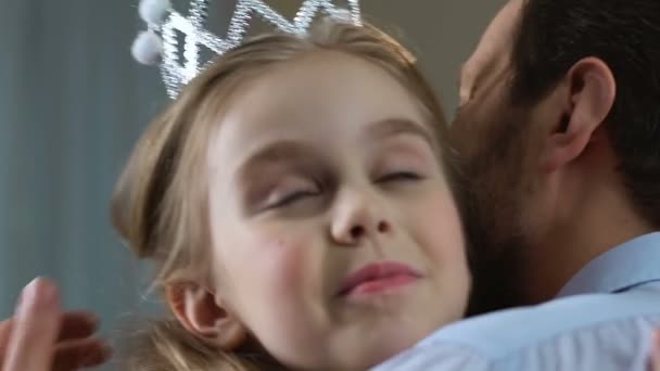 Feliz padre abrazando a la pequeña hija con corona de princesa y vestido, admirando al niño — Vídeos de Stock