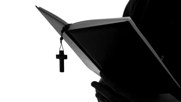 Priest silhouette reading Bible, celebrating Mass, religious sect, close up — Stock Video