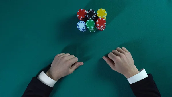 Risky poker player bets all-in, man stakes money on business project, gambling