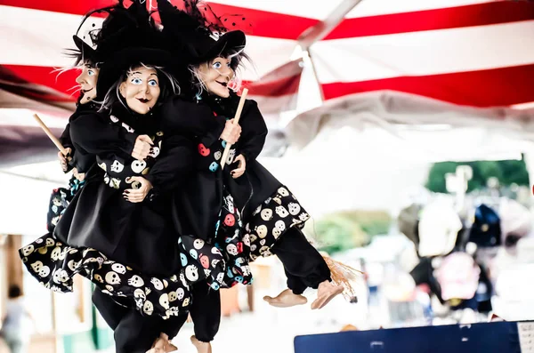 Black witch with broom dolls for sale in a market. — 스톡 사진