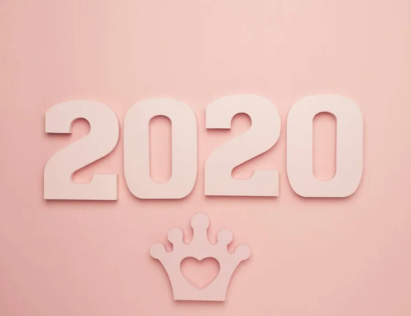 Creative inspiration concepts 2020 with text number and crown on the color background.Business resolution, action plan ideas.Pink color pale shades.