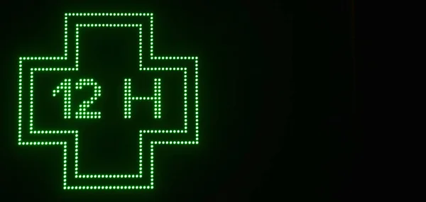 green cross of pharmaceutical electronic products with black background