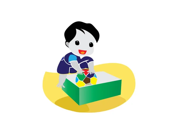 Bir çocuk topu tahta bir kutuya koyarak top oynuyor..