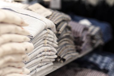 Stacks of colorful shirts with blur in the foreground and background