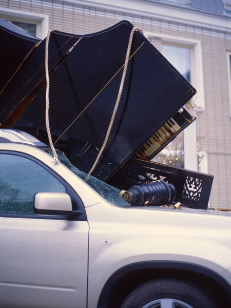 No more music. Piano dropped down from the balcony onto the car.