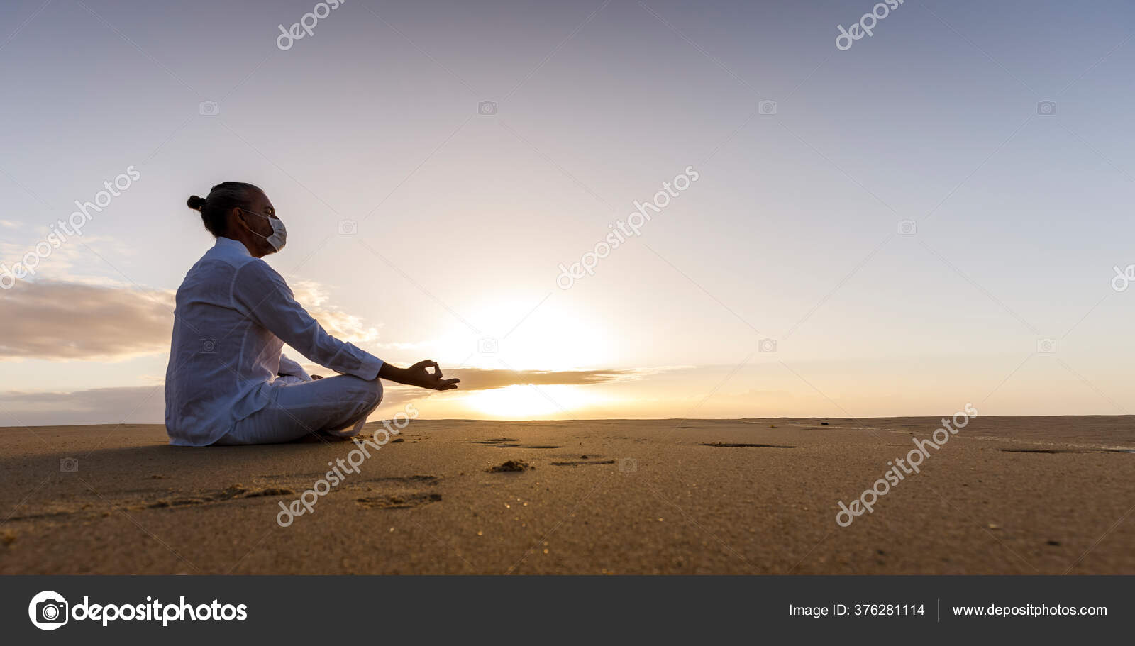 Man in yoga pose at beach Stock Photo - Alamy