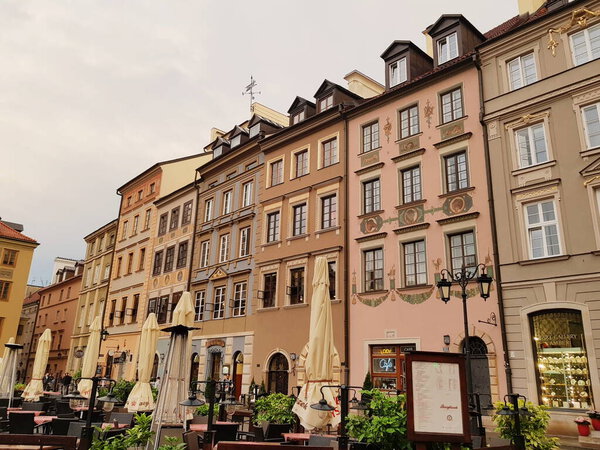 The photo of street in the historic center of Warsaw with old buildings and cozy cafes