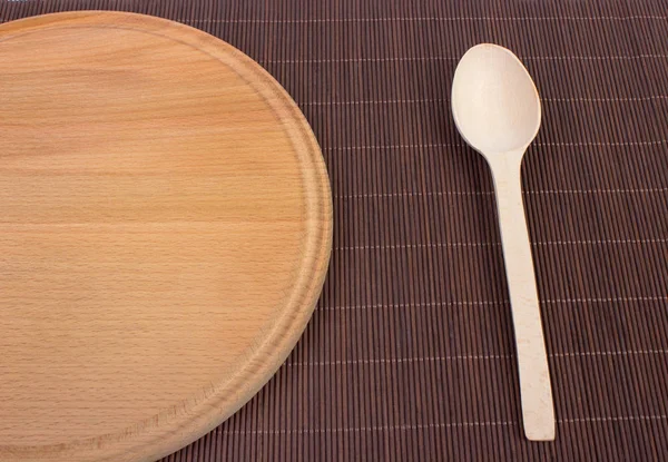 Wooden cutting board and wooden plate — Stock Photo, Image