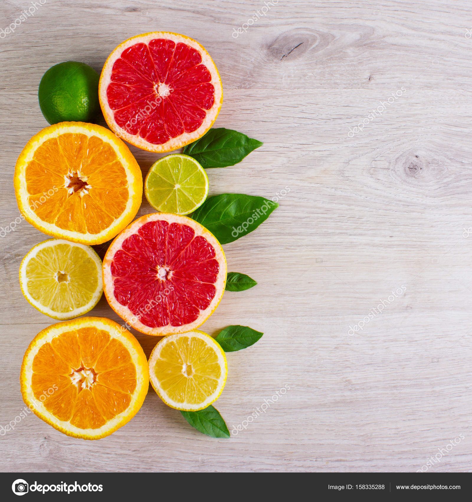 Juicy Citrus Fruits Cut Background Mint Leaf Oranges Lemons Limes Grapefruit Mint Leaves On A Bright Wooden Background Stock Photo C Snegok1967