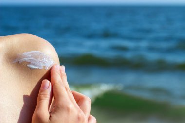 Kumsalda güneş losyon uygulamak kız