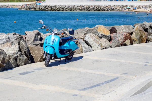 motorcycle near sea coastline. Scooter parked near the beach.