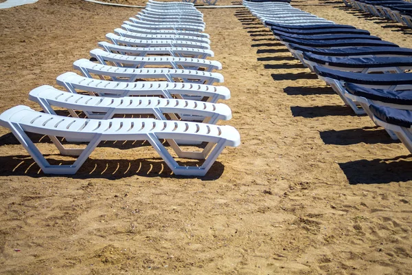 Row of beach beds on an empty beach selective focus.