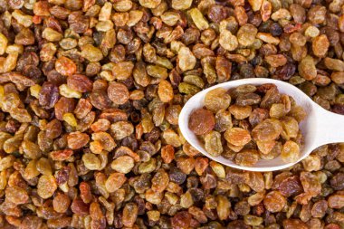 Kuru üzüm ve tahta kaşık yakın gıda arka plan-