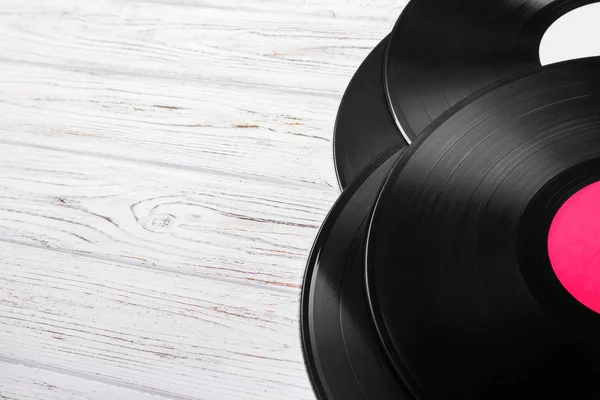 Top view of vinyl records stack over light wooden table with copy space for text — Stock Photo, Image
