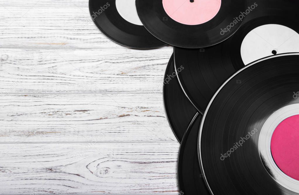 Old black vinyl records on white wooden background. vintage filtered. Copy space. Top view