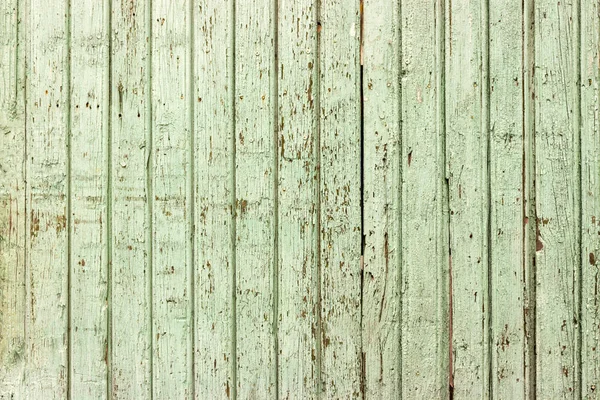 Bright green wooden background with peeling paint and vertical boards — Stock Photo, Image
