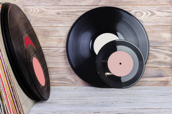 Vinyl record in front of a collection of albums, vintage process. Copy space for text. — Stock Photo, Image