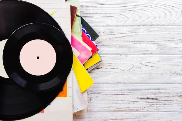 Old vinyl record on the wooden table, selective focus and toned image — Stock Photo, Image