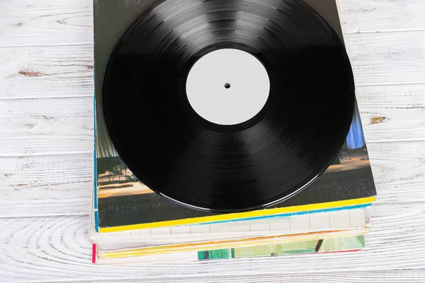 Black vinyl records on the wooden table, selective focus with copy space. Top view — Stock Photo, Image