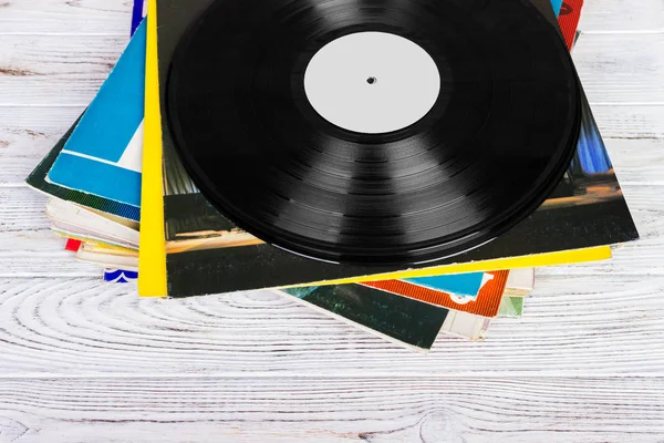 Pile of old vinyl records on wooden background — Stock Photo, Image