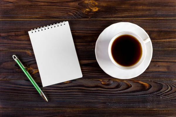 Blank paper and coffee cup on wood table Royalty Free Stock Photos