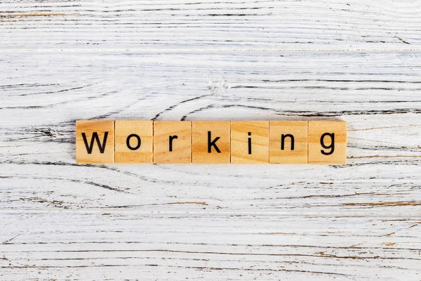 WORKING word written on wood block. WORKING word on block concept — Stock Photo, Image