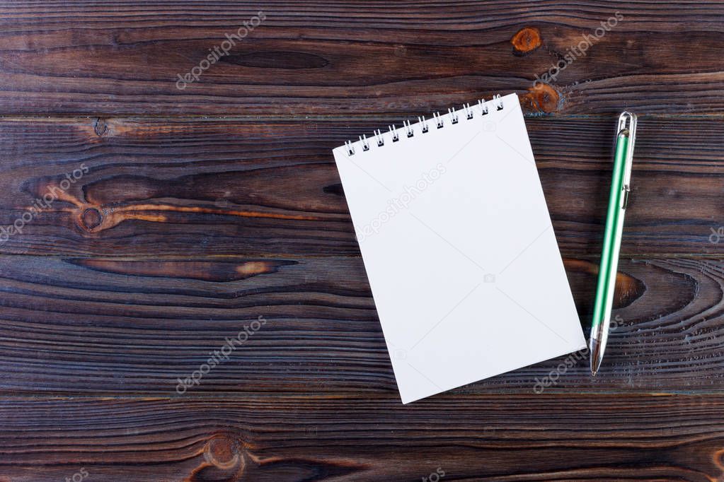 Pen and Notepad on the wooden desk