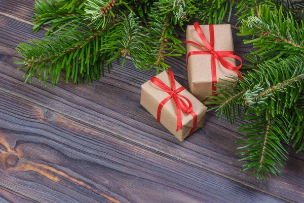 Новорічні фону з Різдвяний подарунок на дерев'яні фону з ялиці філій. Xmas та новим роком складу. Плоскі мирян, top погляд — стокове фото